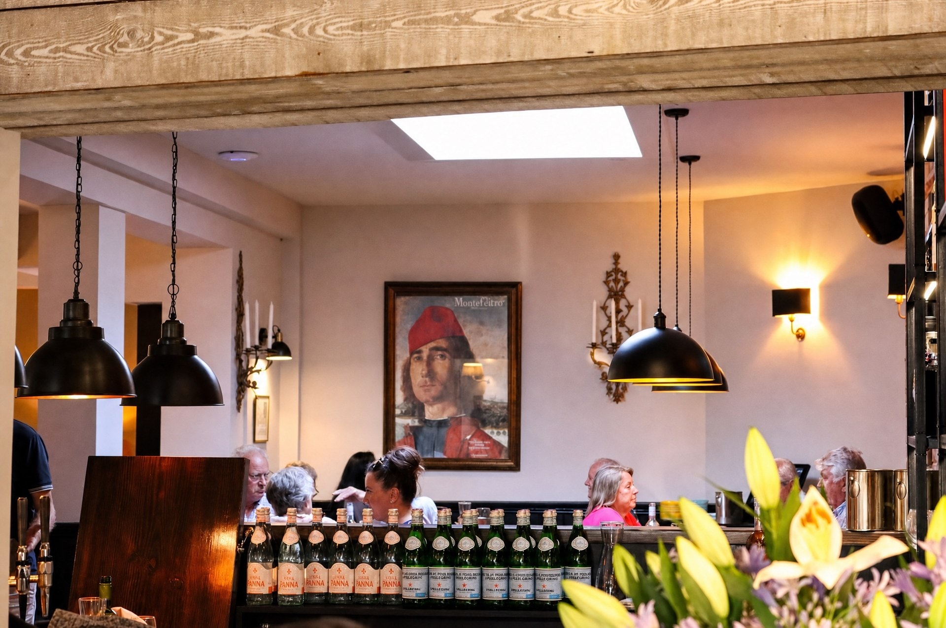 The bar at Latimers restaurant in Romsey, warm pendant light and exposed brick