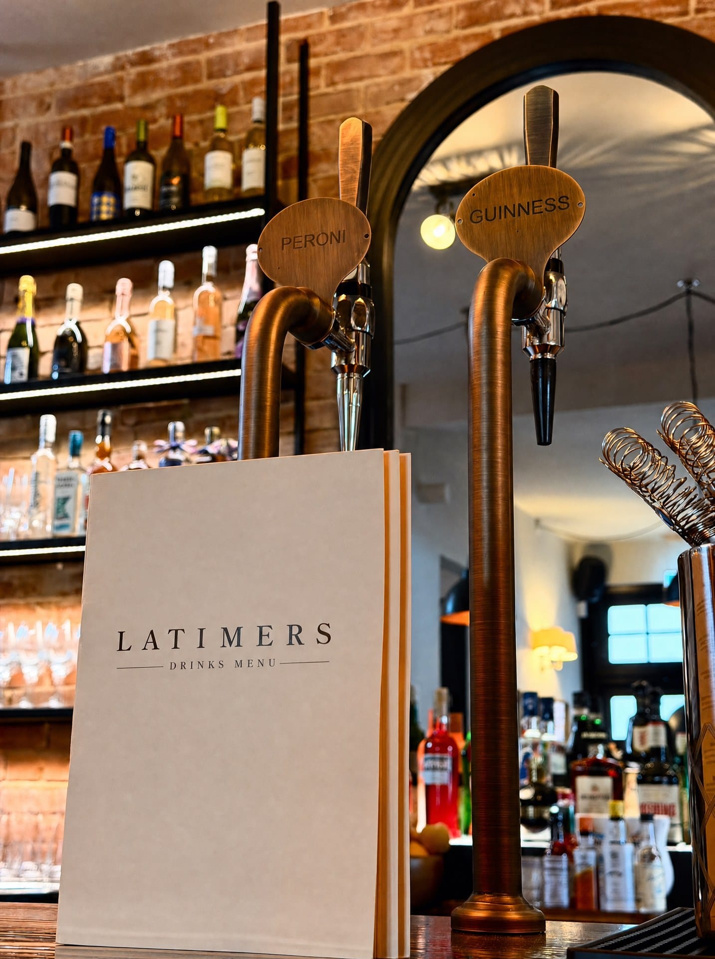 The bar at Latimers in Romsey, with the menu standing by the taps